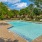 Spacious sparkling pool with sundecks and cabanas for lounging.